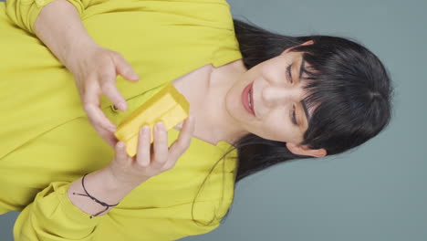 Vertical-video-of-Happy-and-joyful-woman-opening-gift-package.